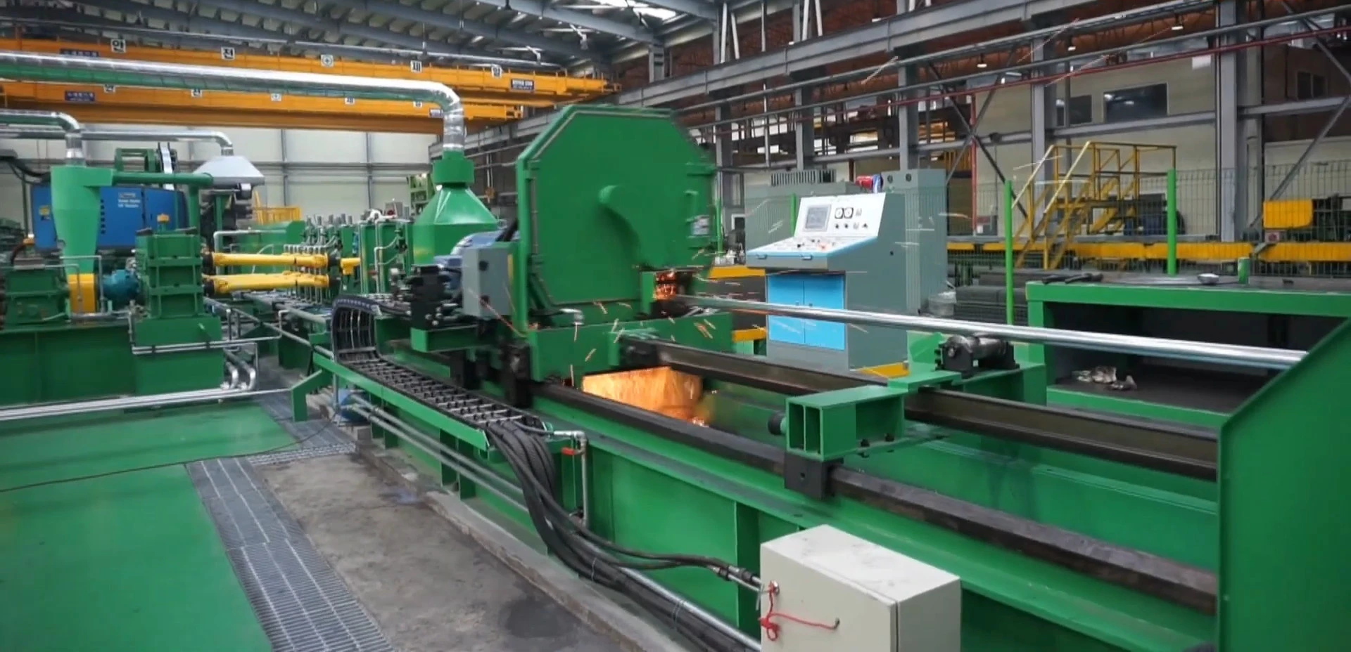 Carbide saw blade cutting steel tube on a tube mill line