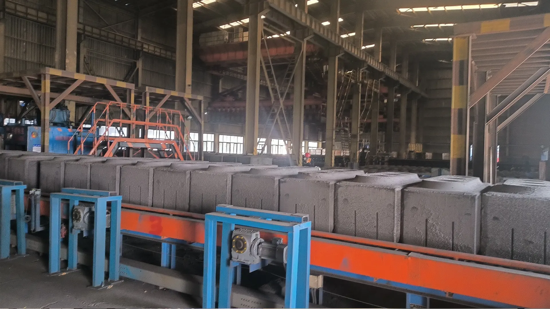 Primary aluminum smelter where prebaked carbon anodes are slotted