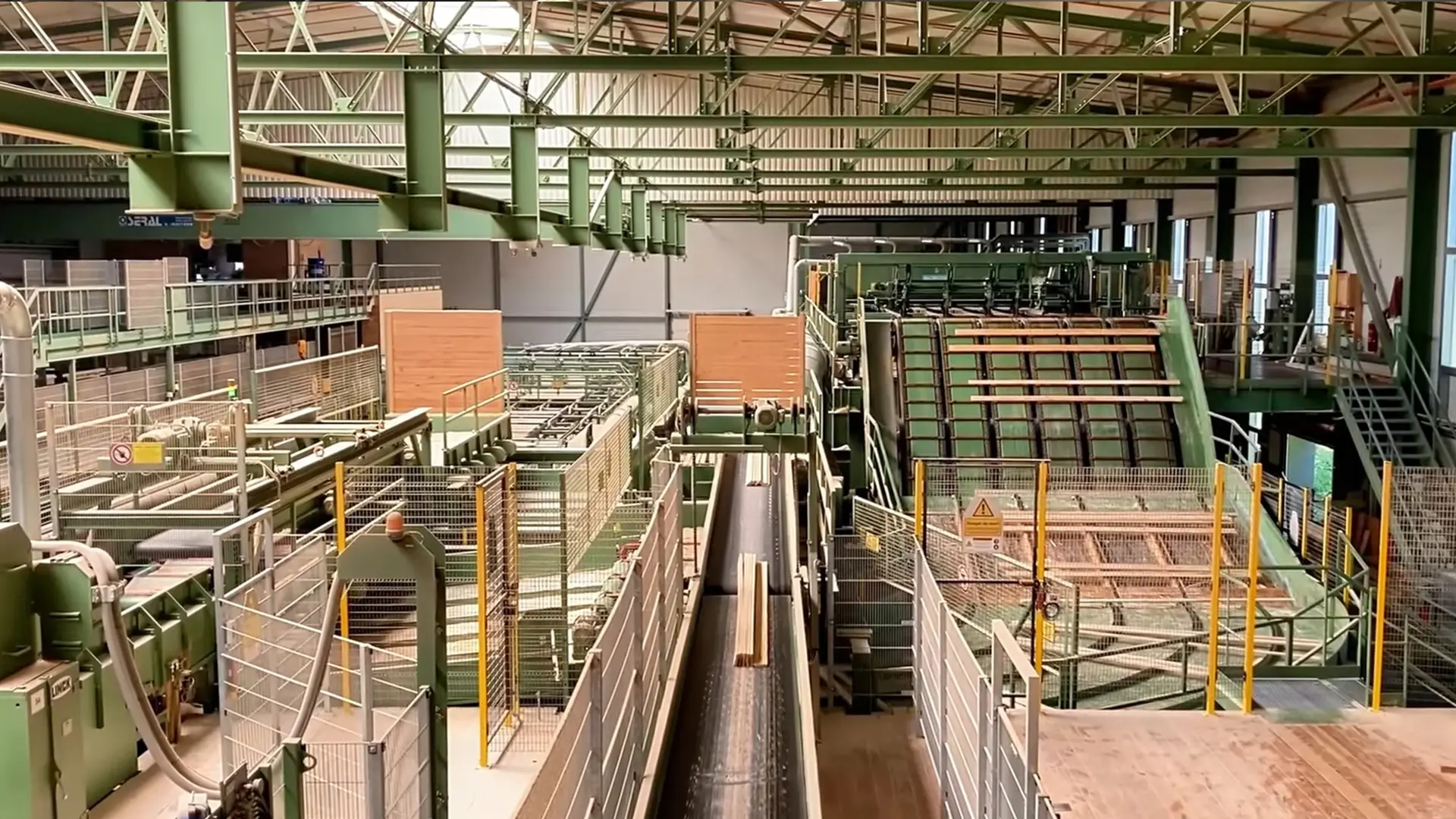 Automated primary sawmill line breaking down logs into lumber